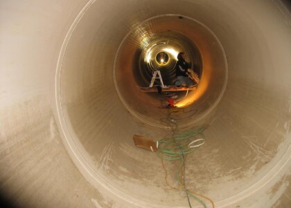 Applying a plastic liner inside of large pipe