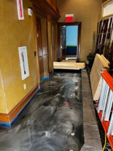 Installing resinous flooring in restaurant hallway